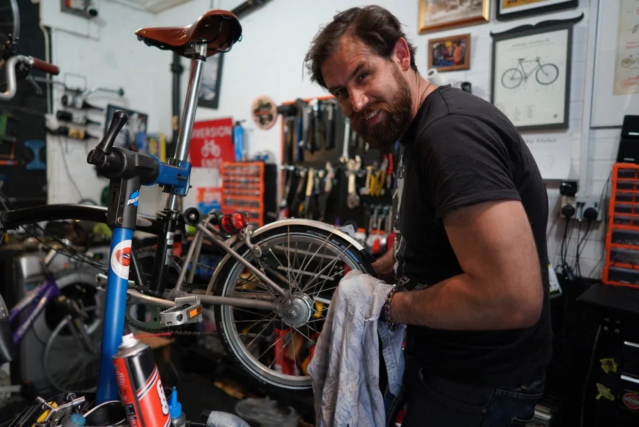 A mechanic working on a bike in the studio